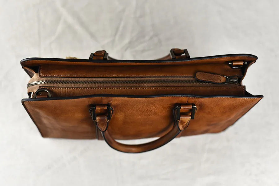 Men's brown leather handbag with horizontal design and zipper opening