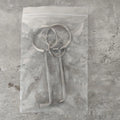 Two silver alloy universal wrench tools side by side on a surface.