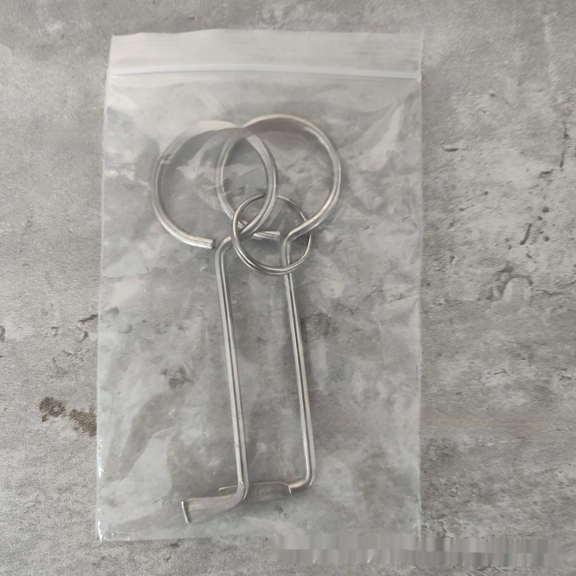 Two silver alloy universal wrench tools side by side on a surface.