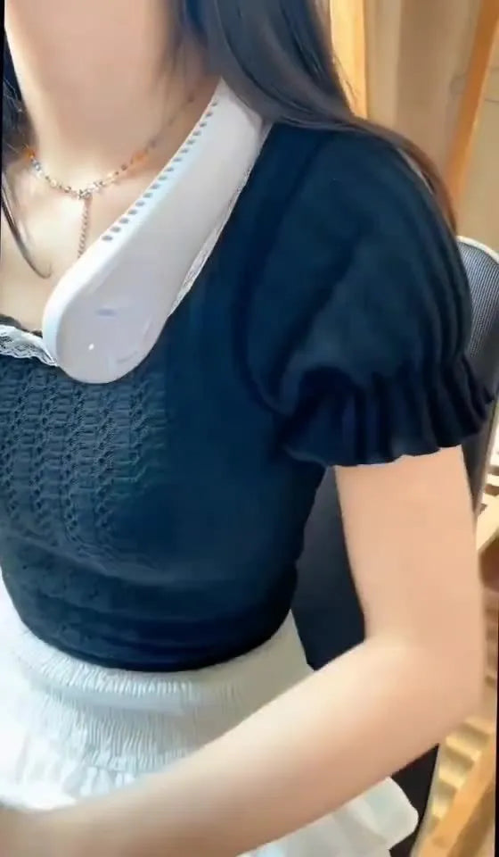 White bladeless neck fan hanging around neck with USB charging cable
