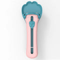 Green and pink pet food squeezer spoon for dispensing treats and liquid food to cats and dogs.