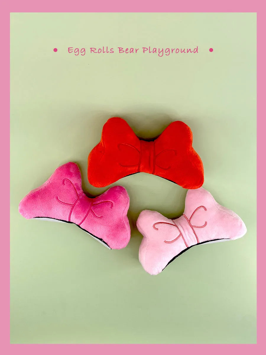 Large soft plush bow decoration for motorcycle or ski helmet in red, peach pink, or rose pink.