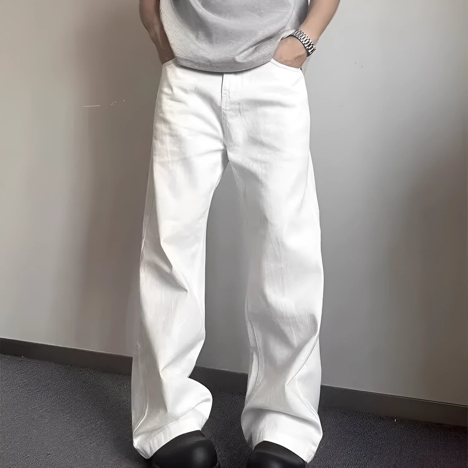 Men's loose straight leg white cotton denim jeans on a hanger.