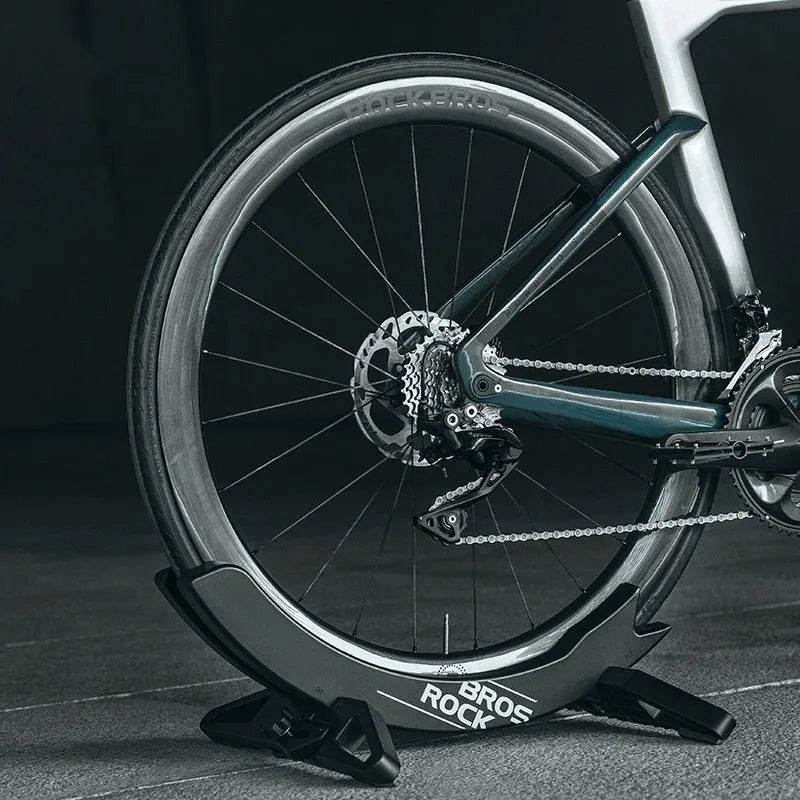 Black and green ABS plastic fixed bracket for mountain bike and road bike parking.
