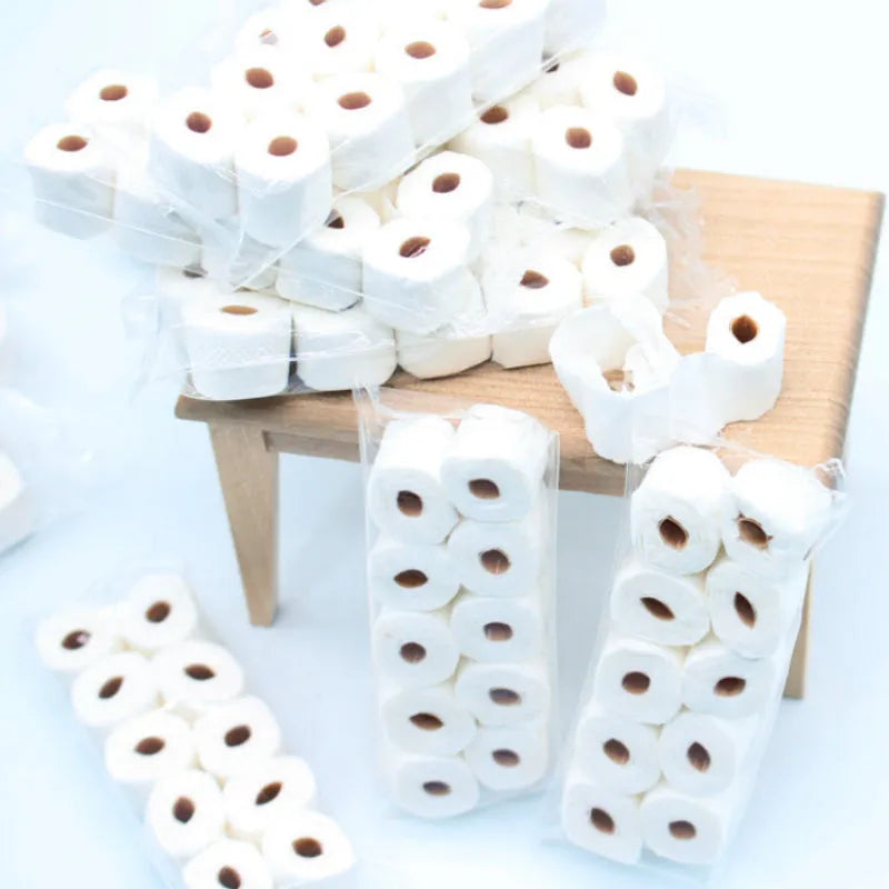 Small paper model of a tissue roll on a core, measuring 30mm by 15mm by 80mm.