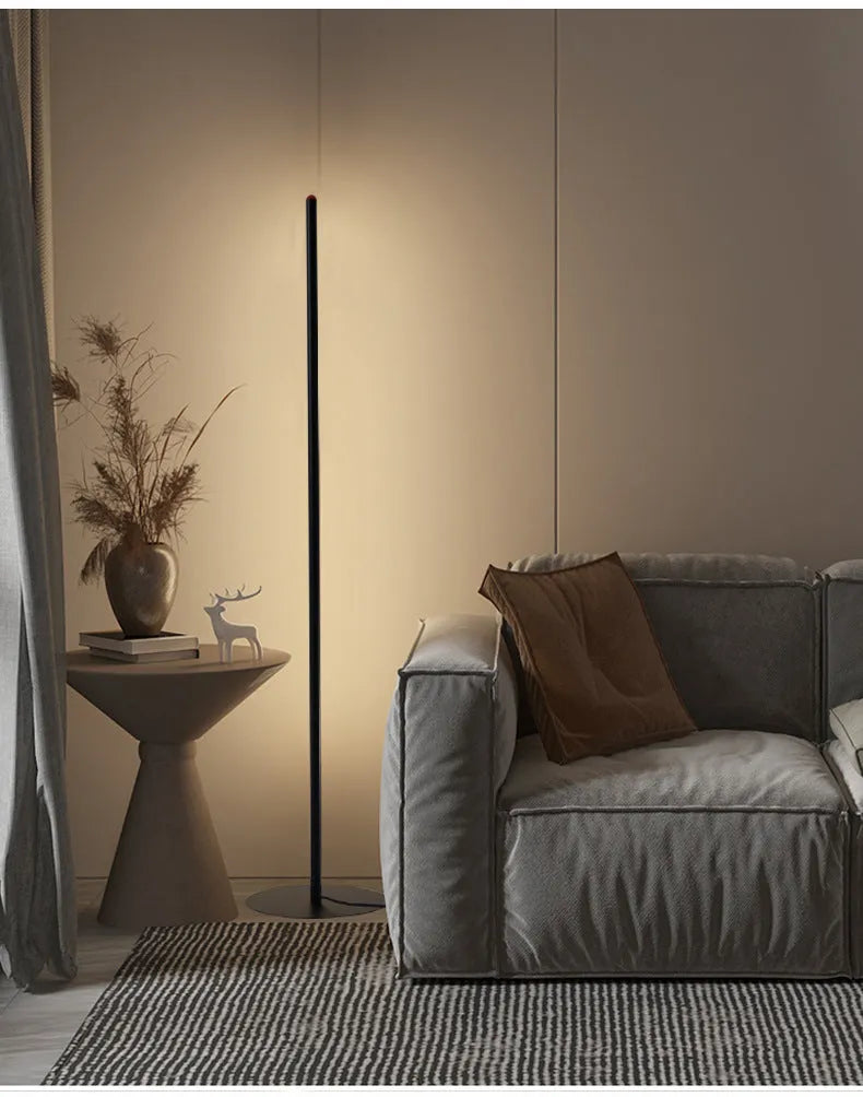 Vertical aluminium floor lamp in modern simple style shown at different heights on a table.