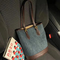 Denim patchwork bucket handbag showing patchwork detailing and one-shoulder strap