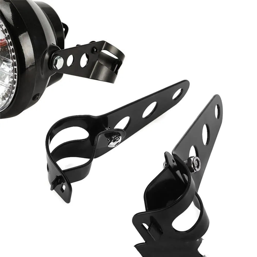 Pair of black iron motorcycle headlamp support brackets shown from the side