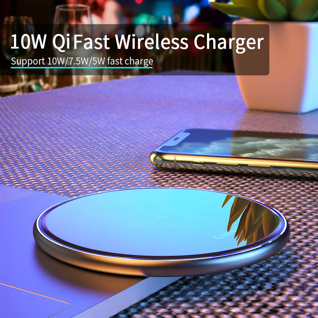 Black Qi fast wireless charging pad for smartphones on a desk