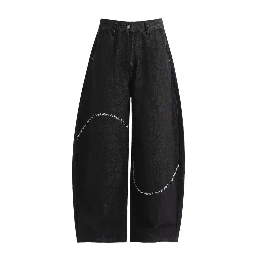 Black straight-leg jeans trousers with mid waist and zip placket closure on teenage model