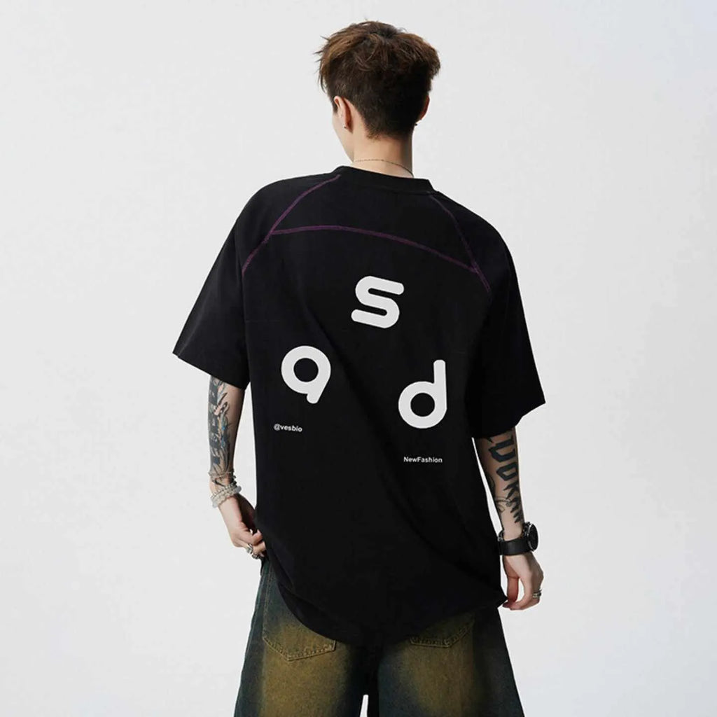 Loose fit black cotton t-shirt with letter print graphic on front, short sleeves, and round neck.