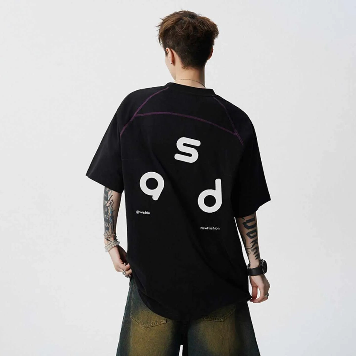 Loose fit black cotton t-shirt with letter print graphic on front, short sleeves, and round neck.