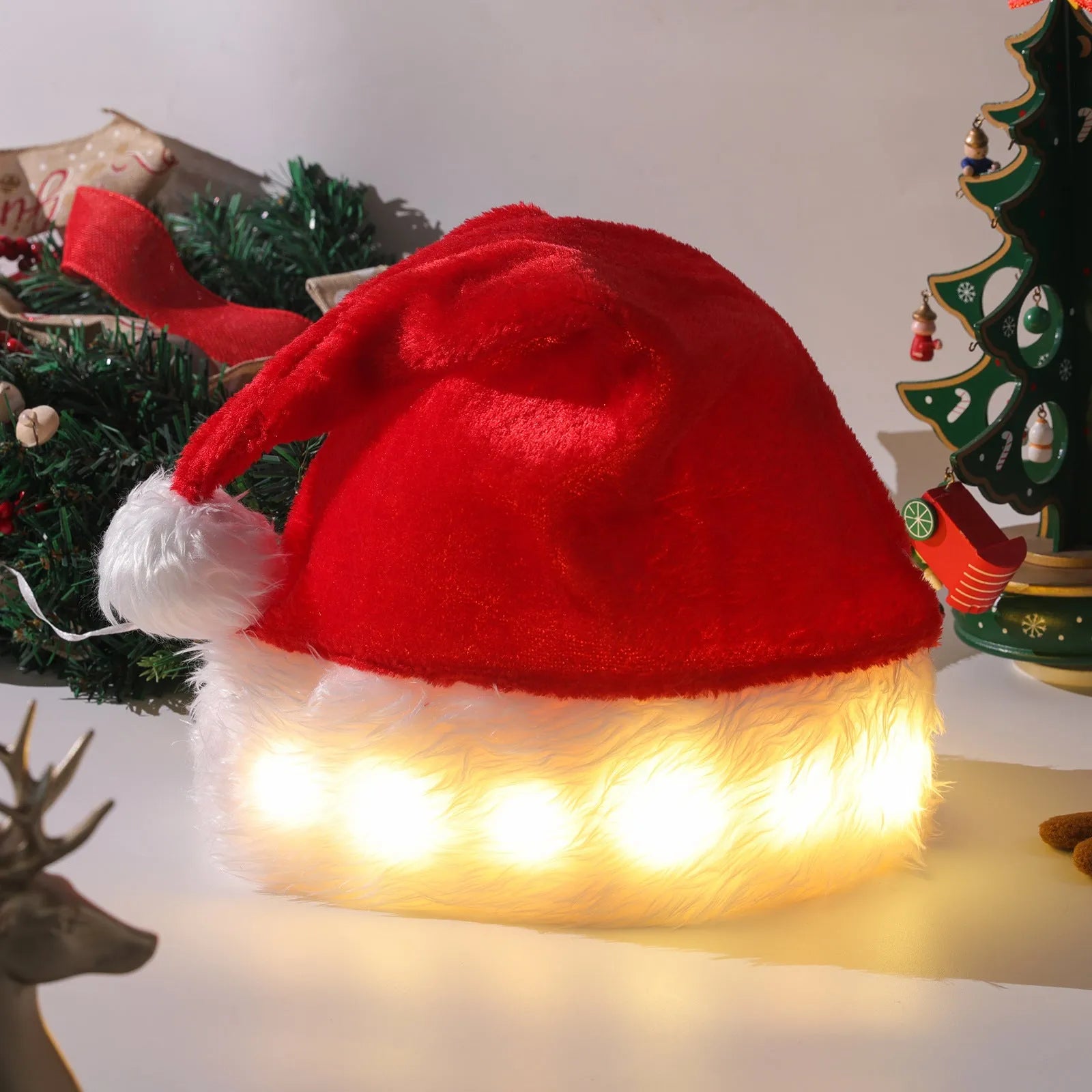 Red and white plush Santa hat with glowing LED lights around the brim and a white pom-pom.