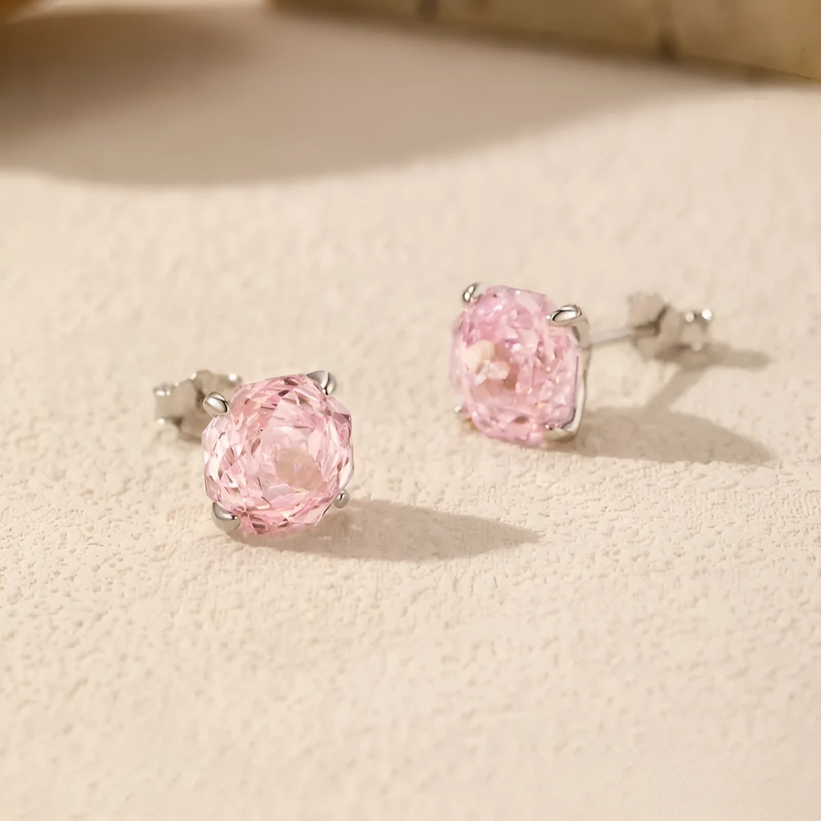 A pair of S925 sterling silver stud earrings featuring a detailed rose flower design, shown in two size options.