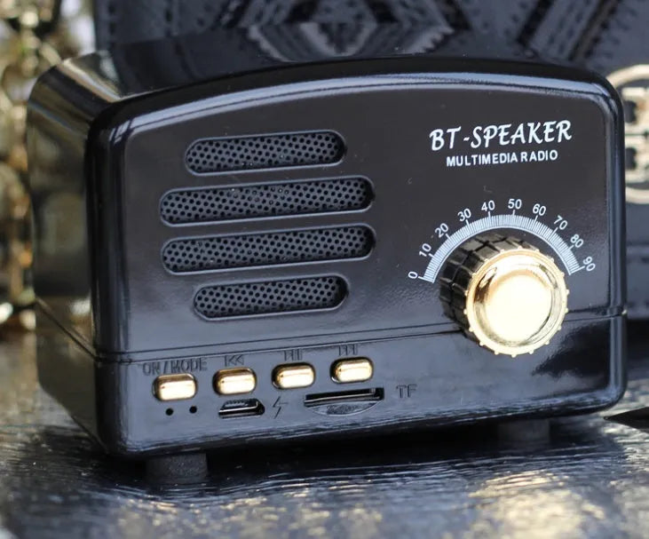 Vintage wood effect Bluetooth speaker in pink, black, and wood grain colour options showing compact 93x70x59mm size
