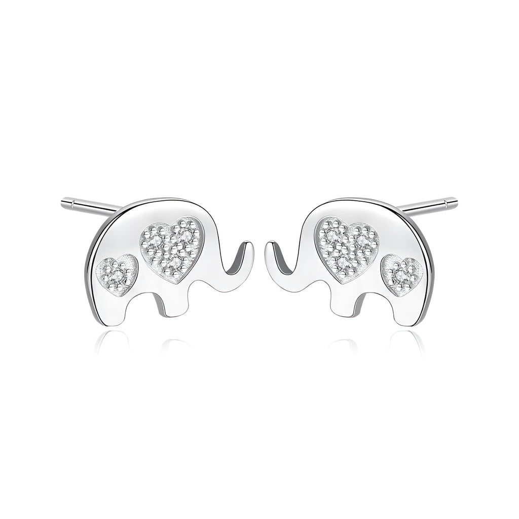 Small geometric silver stud earrings with gold or silvery finish on a grey background.
