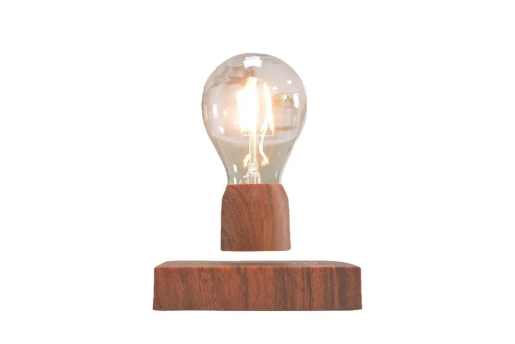 Magnetic levitation floating light bulb hovering above a wood-effect base.