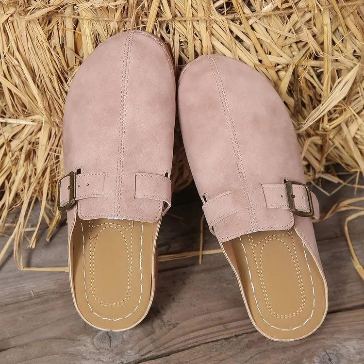 Women's casual wedge slippers in various colours with a cloth upper and rubber sole.
