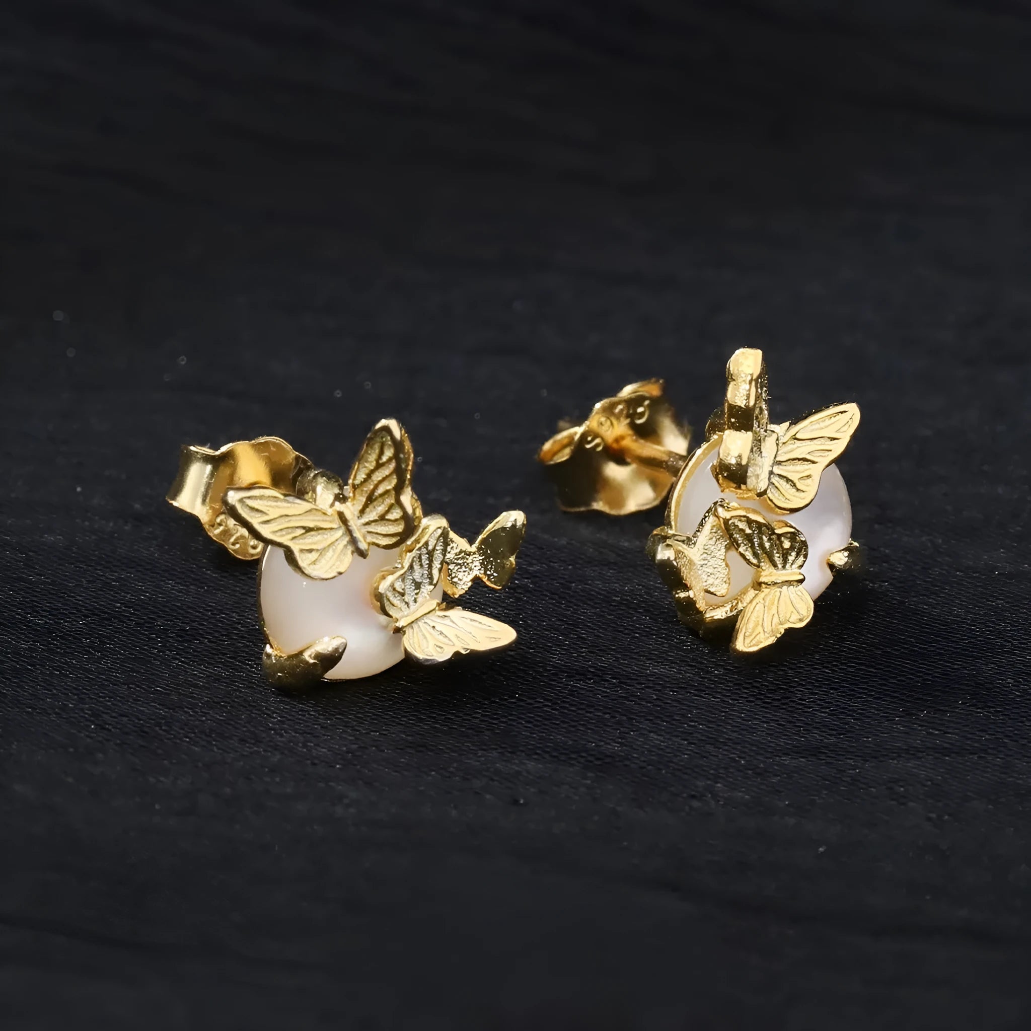 A pair of butterfly-shaped stud earrings in 925 silver with a gold electroplated finish.