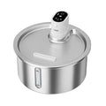 Stainless steel heated pet water fountain with white control base on a wooden floor.