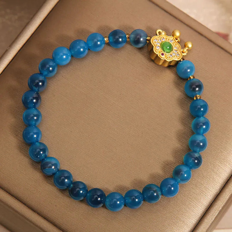 Women's blue sugar heart agate safety lock pendant bracelet with crystal and rhinestone details on alloy.