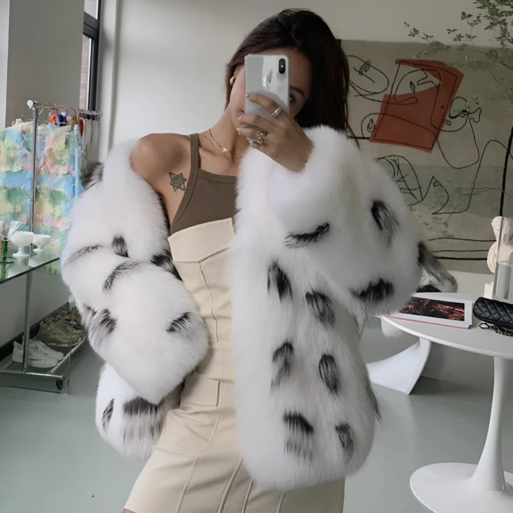 Black and white women's plus size short faux fur coat with regular sleeves on a model.