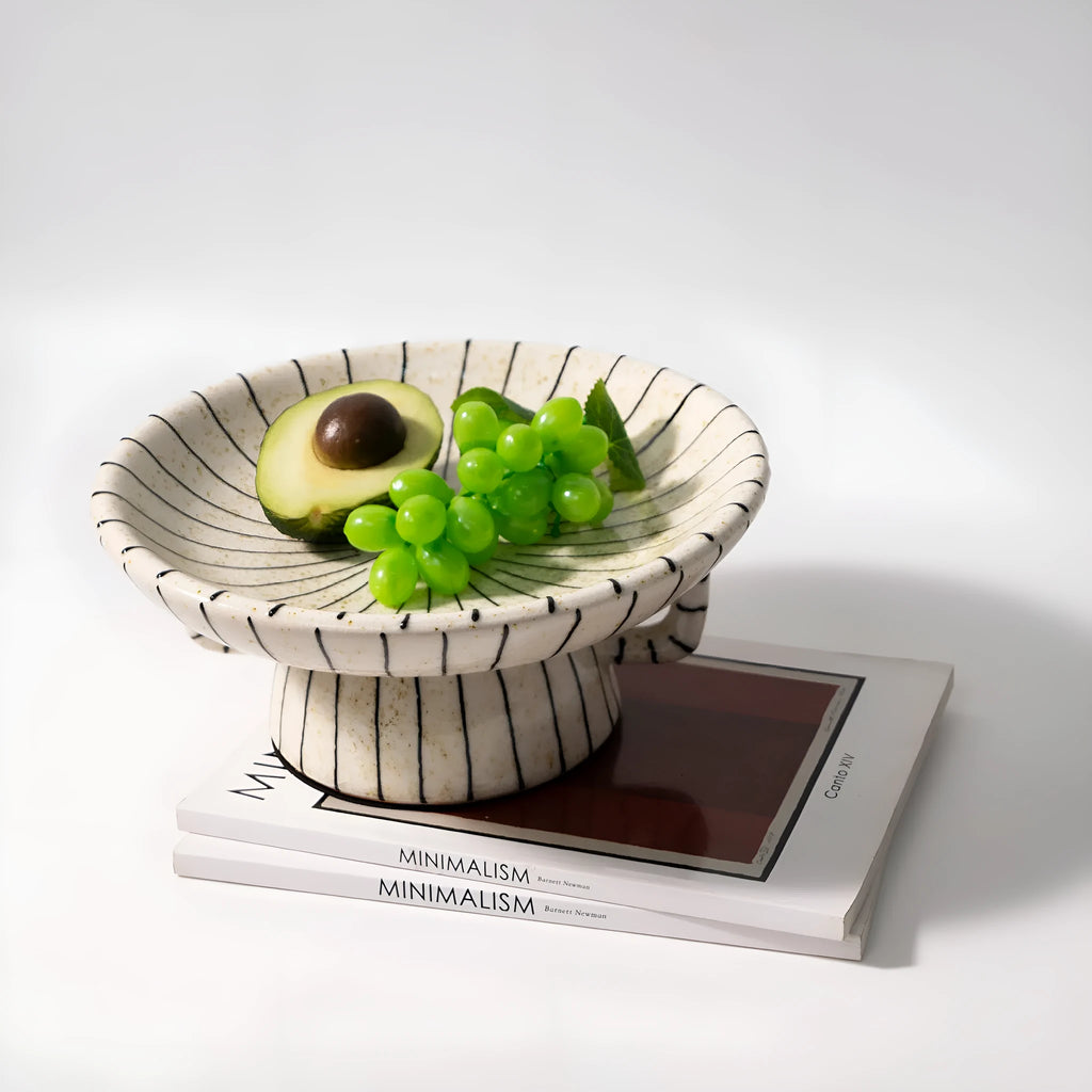 Black and white striped plastic resin fruit plate ornament, 16cm diameter, on a table.