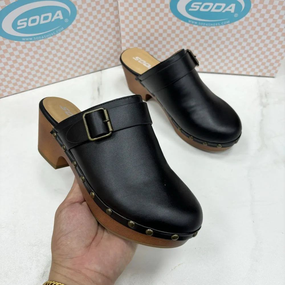 Black retro chunky heel closed toe slippers with rivet detail on a rubber sole.