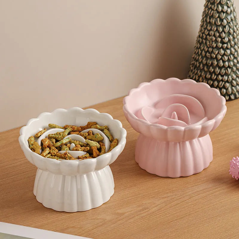 Ceramic slow feed dish with flower pool design and higher edges for cats and small dogs, shown in pink.