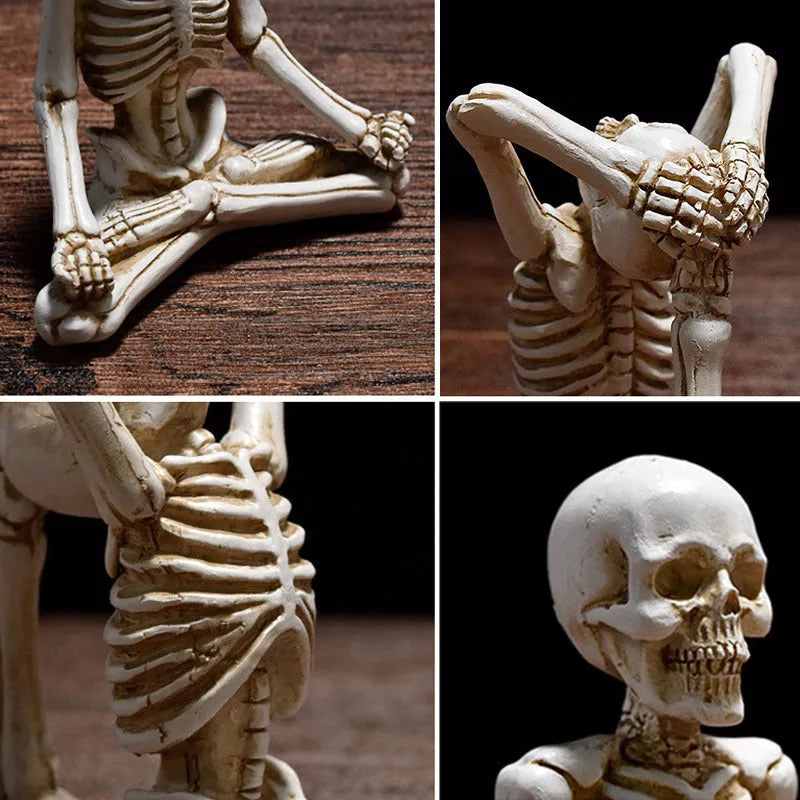 A detailed resin desktop ornament of a yoga-pose skeleton skull in black and white colour options.
