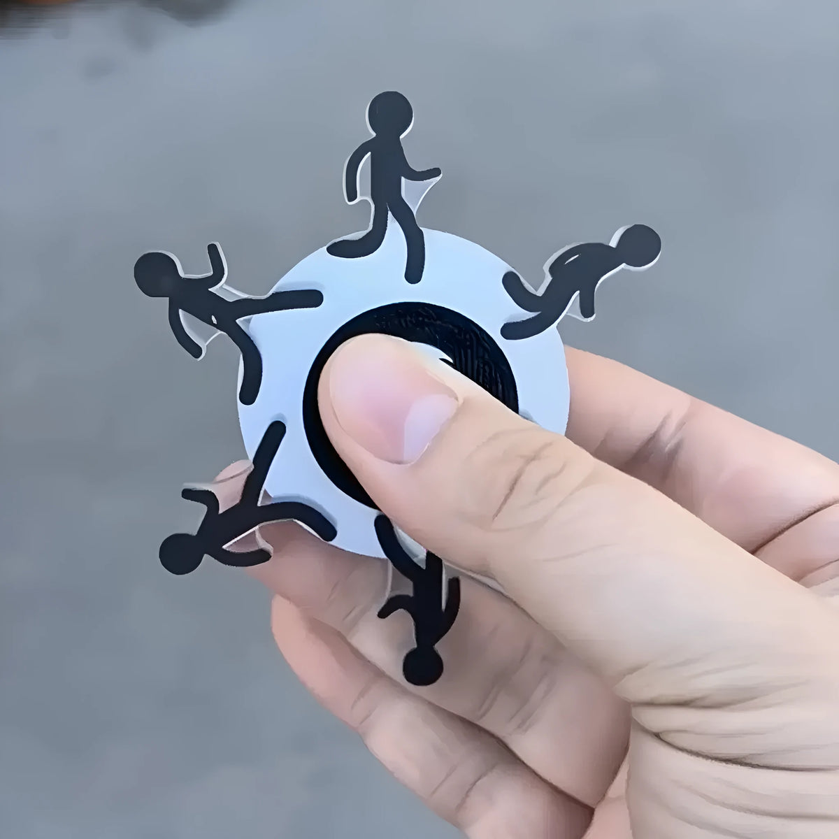 Acrylic stickman running fingertip gyro in colourful runner design on a plain background