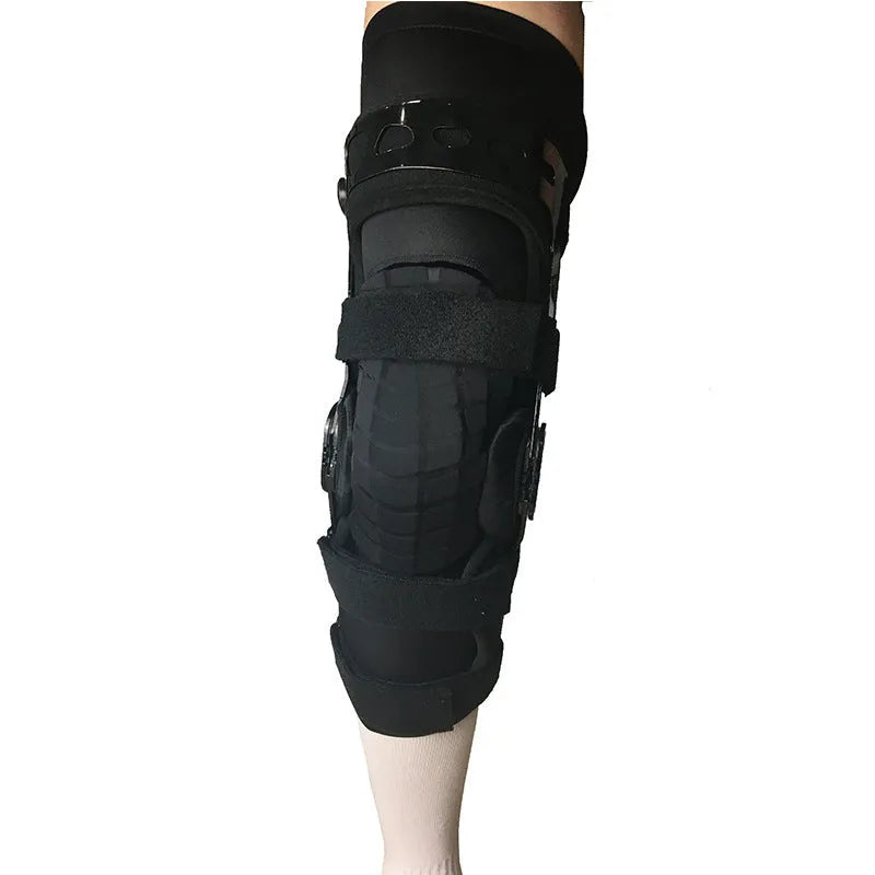 Black anterior ligament knee pad with visible metal stabiliser, shown in a left-leg size.