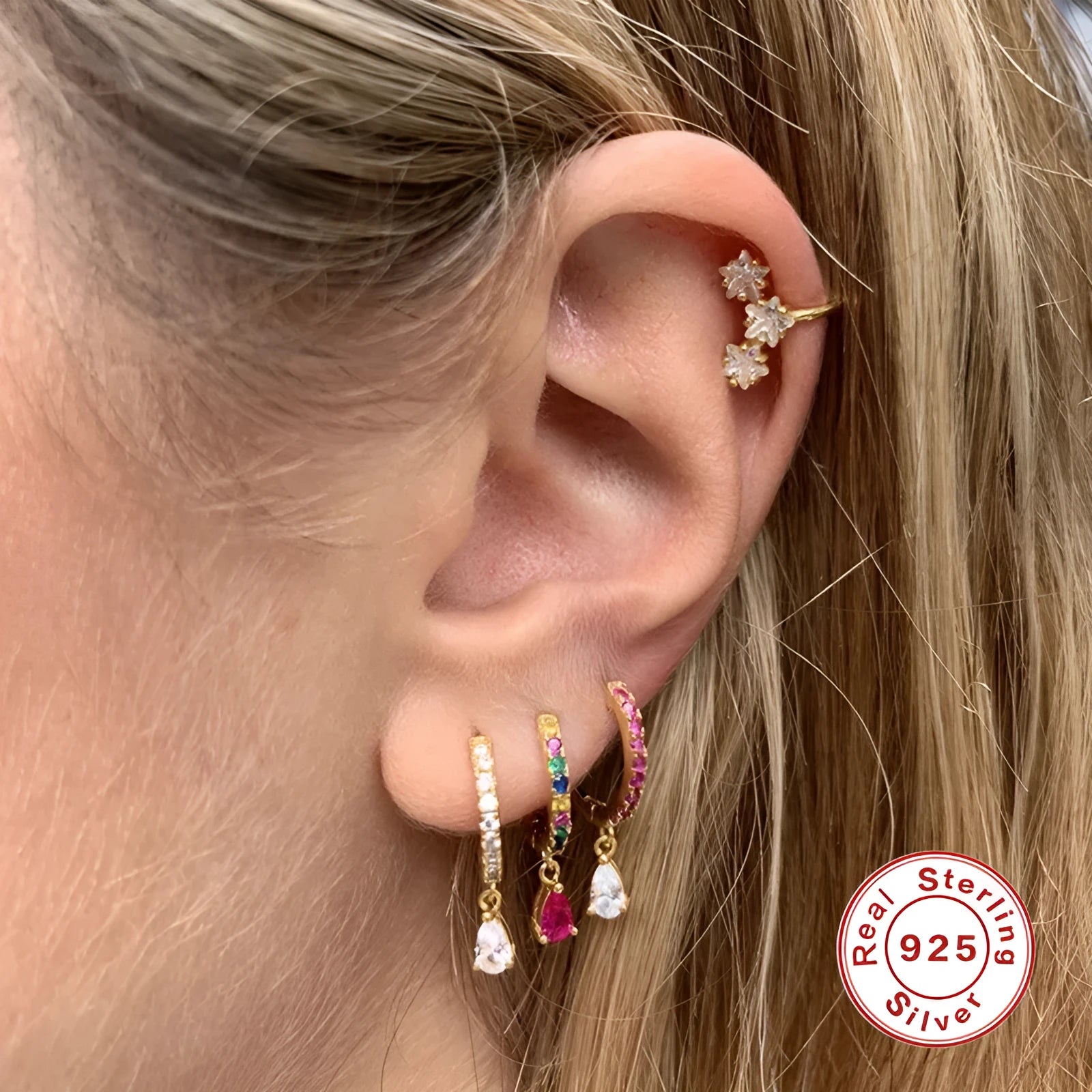 A pair of S925 sterling silver geometric water drop stud earrings on a gold or silver background.