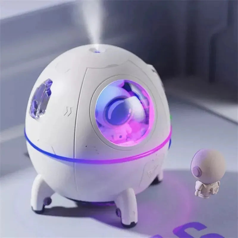 Light purple astronaut-shaped desktop USB humidifier with LED lights on a desk
