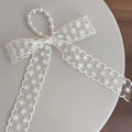 Fabric hair clips with lace, bow, and pearl butterfly designs for women
