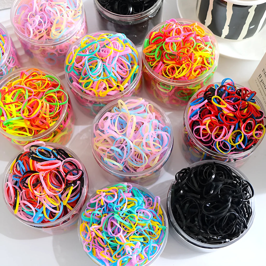 Multicoloured TPU baby hair ties in a reusable transparent storage container