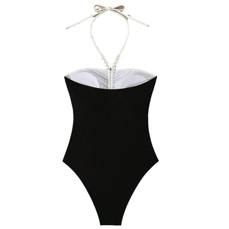 Black and white women's one-piece swimsuit with pearl spaghetti straps, sleeveless slim-fit design.