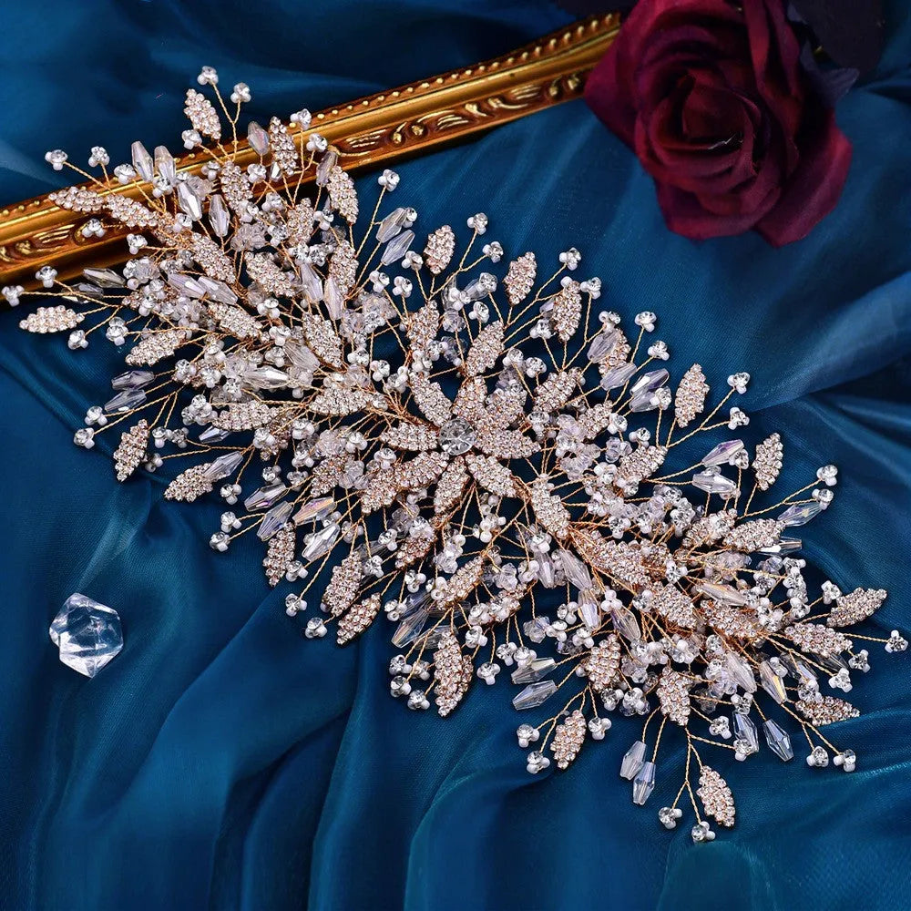 Gold rhinestone wave bridal headpiece and matching earrings set on display