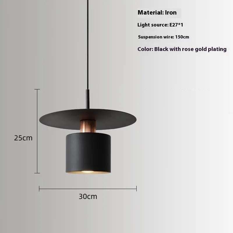 Modern minimalist black droplight pendant 20cm diameter on ceiling over a bedside table