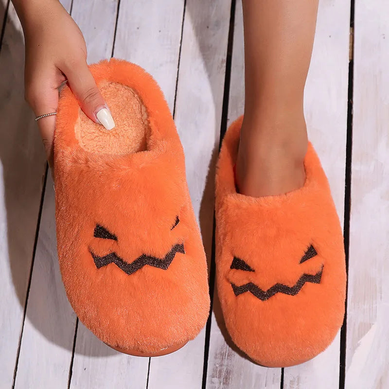 Orange Halloween pumpkin slippers with plush lining and a textured non-slip PVC sole.