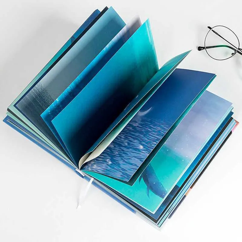 Chinese Style Whale A5 hardcover notebook with colour pages, lying open on a desk