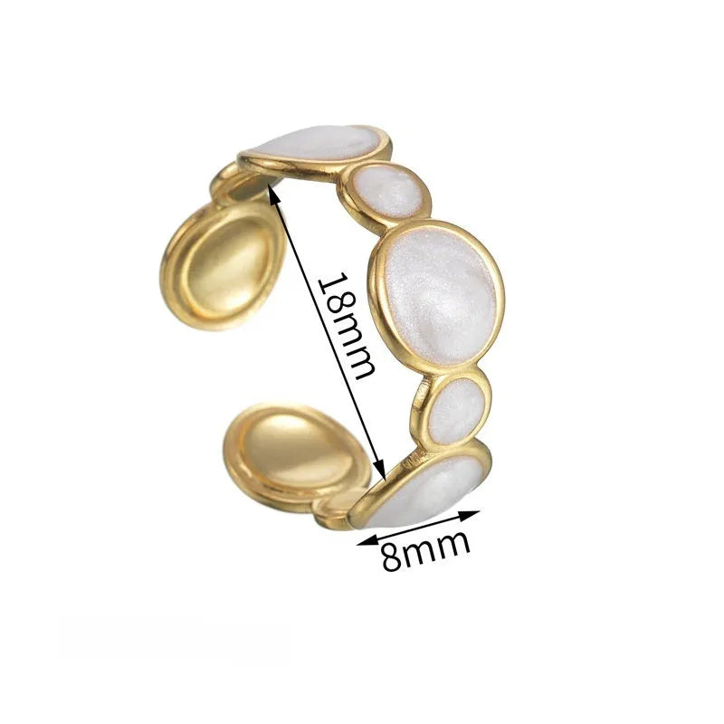 A geometric stainless steel ring with an adjustable opening on a plain background.