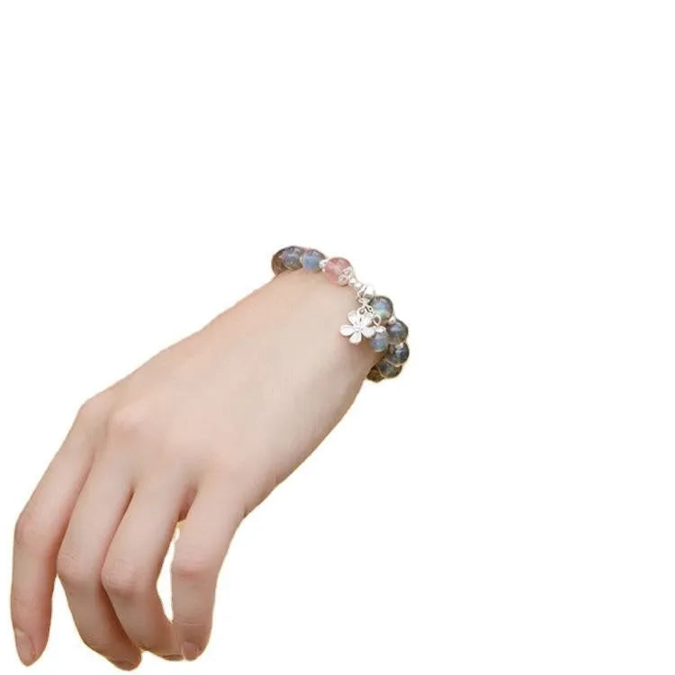 Women's silver bracelet with grey moonstone and zodiac charm.