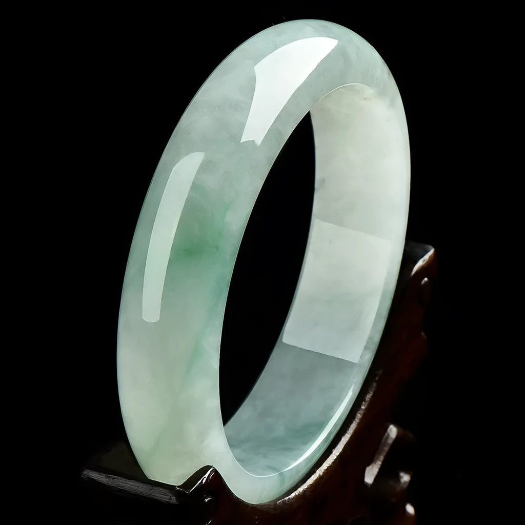 Light green jade bracelet on wrist, natural style, showing sizing scale from 53mm to 64mm