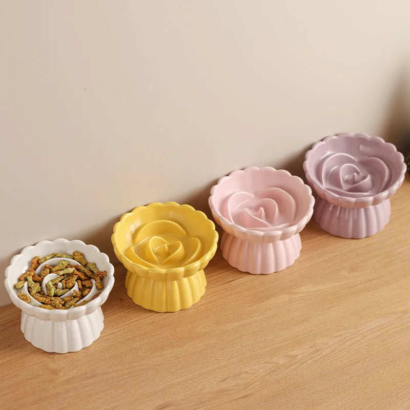 Ceramic slow feed dish with flower pool design and higher edges for cats and small dogs, shown in pink.