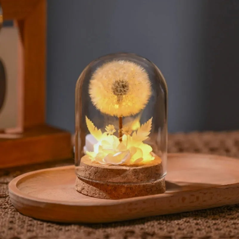 Dandelion-shaped glass night light ornament in gradient colours on wooden surface