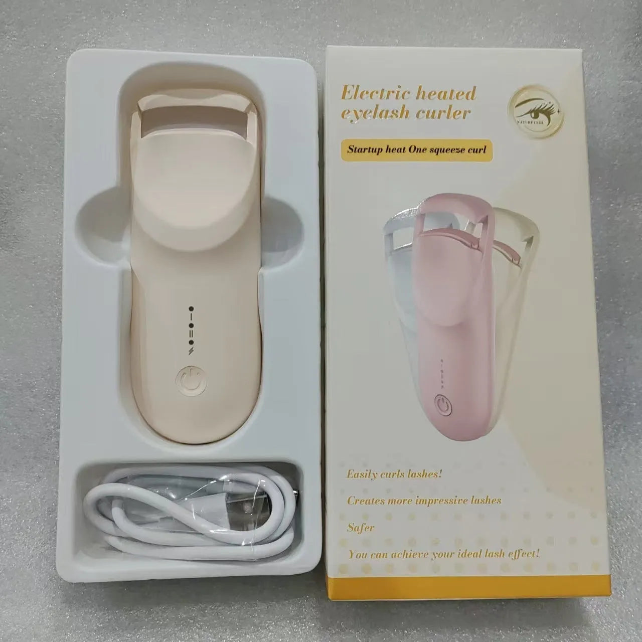 Electric heating eyelash curler in cream white colour with USB charging cable