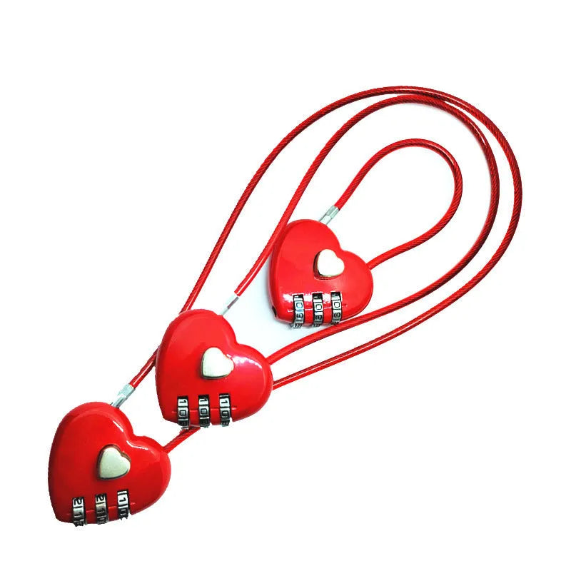 Peach heart shaped wire rope lock in multiple colours with a long steel cable, shown next to a bicycle helmet.