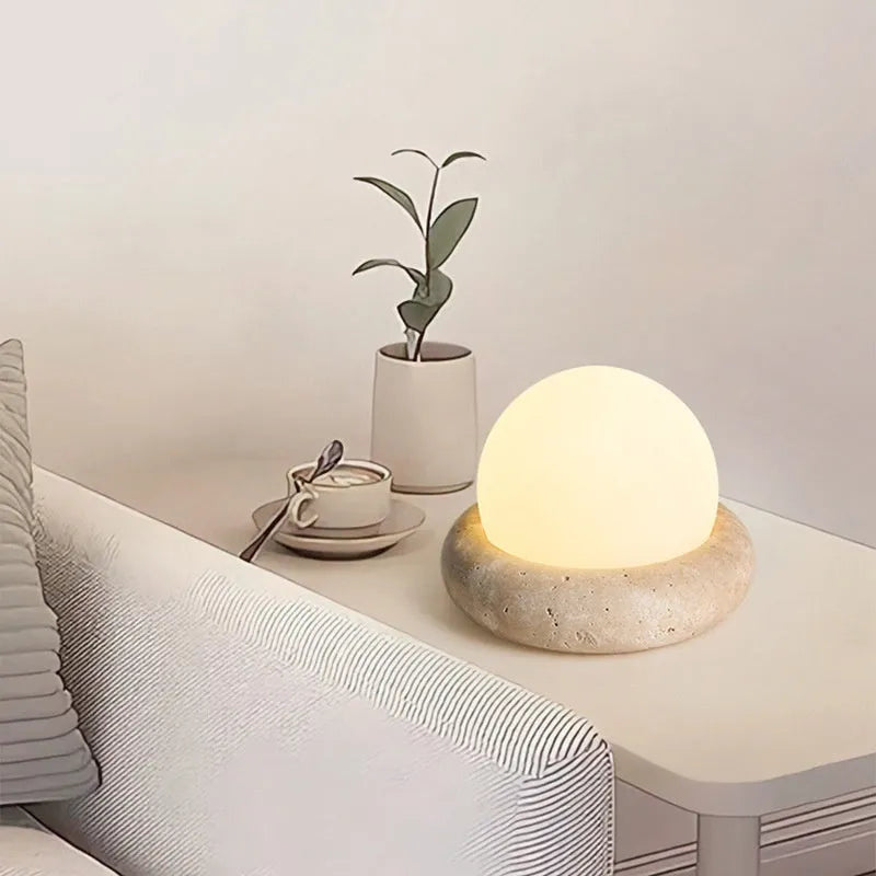 Cream style bedside night light with remote control on bedroom surface
