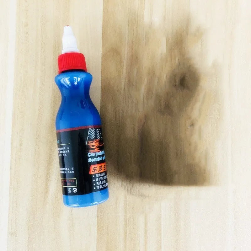 Small blue car scratch repair agent bottle with application tool for automobile bodywork